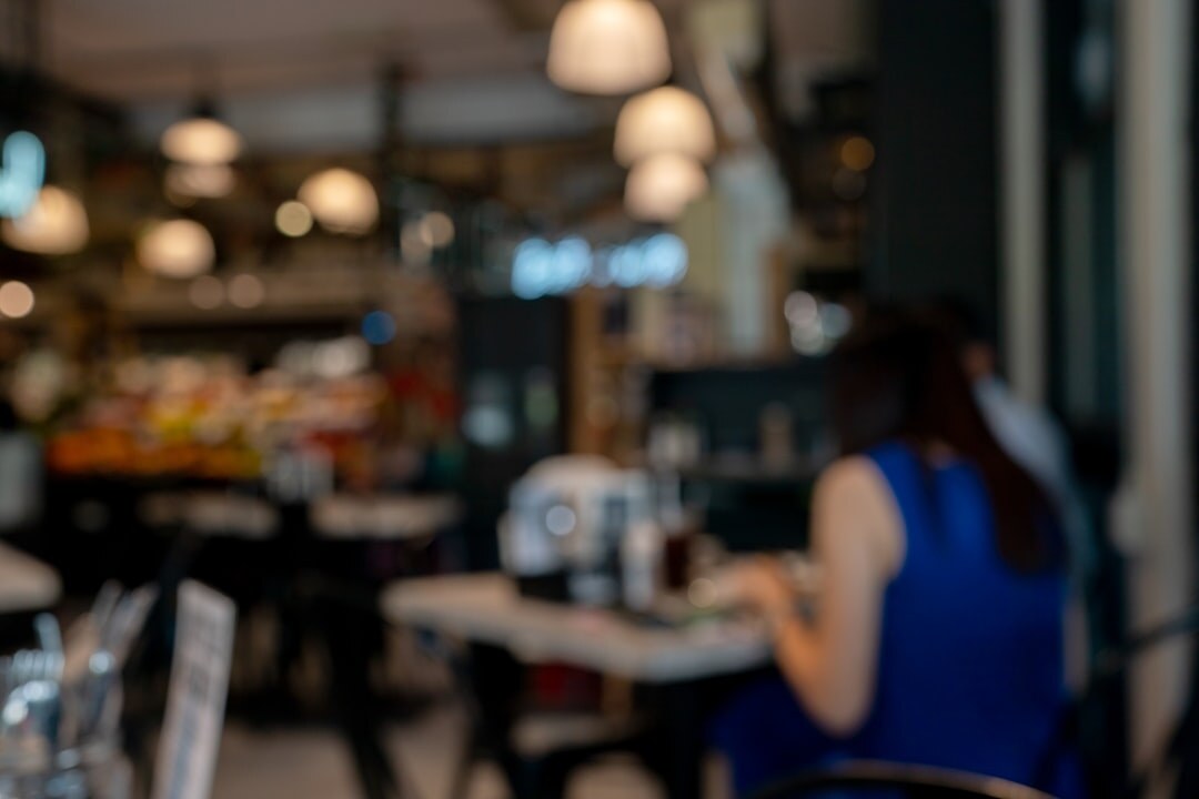 Photographer photographing dishes on a restaurant table