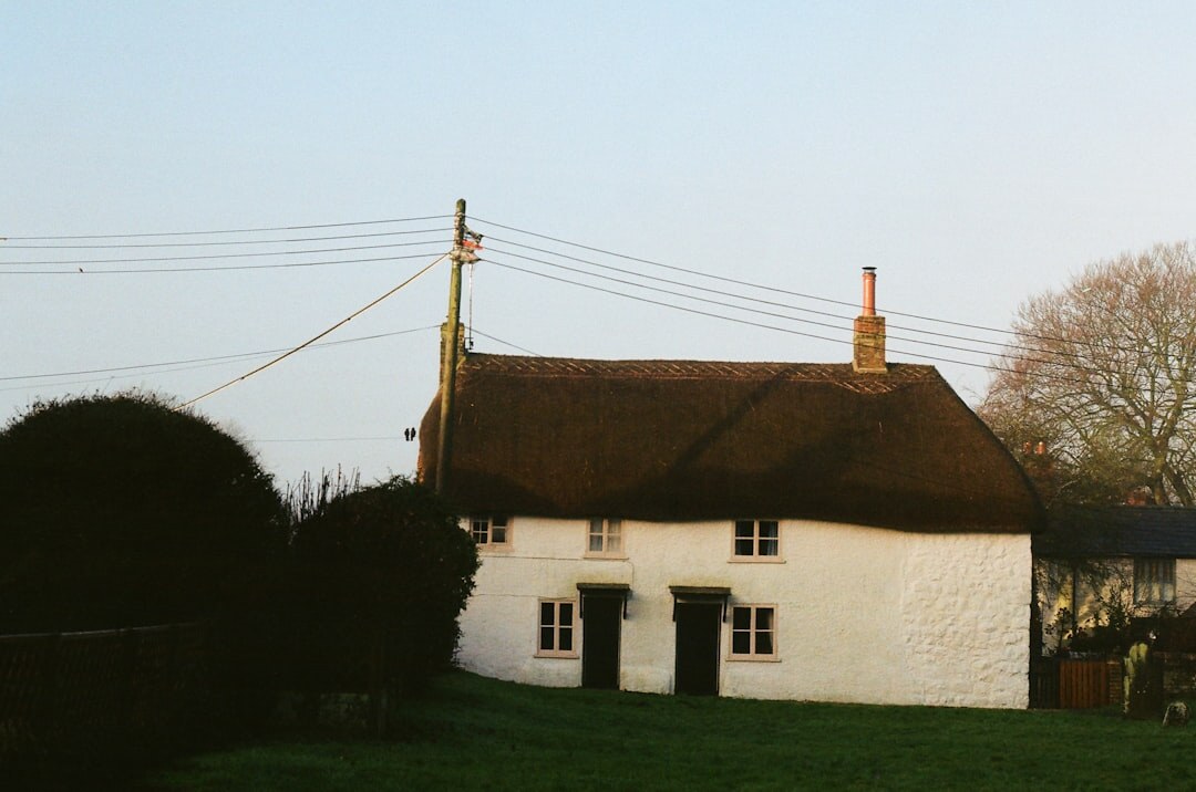 Small countryside inn with warm interior light at dusk