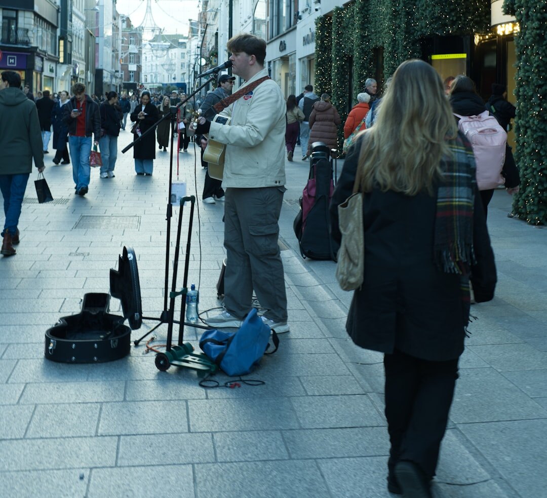 Photographer crouching to photograph a street scene