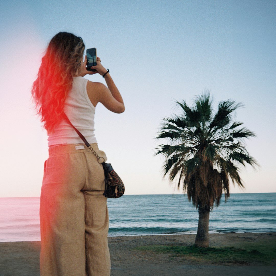 Photographer reviewing shots on camera screen outdoors